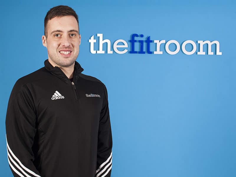 member/trainer of The Fitroom taking picture wearing an Adidas jacket